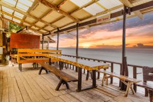a deck with benches and a view of the ocean at Anda De Boracay White Sand Resort in Anda