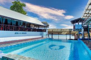 a swimming pool in front of a building at Anda De Boracay White Sand Resort in Anda