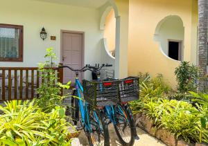 a blue bike parked in front of a house at Coral Apartments in La Digue