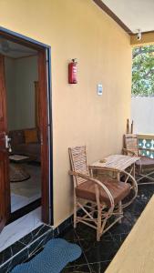 a patio with a table and chairs and a fire hydrant at Zai Homes Watamu in Watamu
