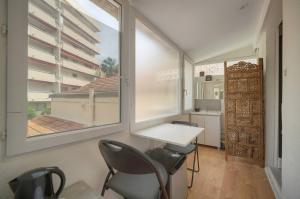 a room with a table and two chairs and a window at FRGK "4 Suites Privées Exclusives" in Cannes
