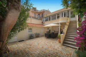 a large house with a patio and a staircase at FRGK "4 Suites Privées Exclusives" in Cannes