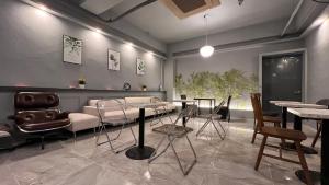 a room with a table and chairs and a couch at Hotel Maru in Seoul