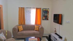 a living room with a couch and a window at Zai Homes Watamu in Watamu