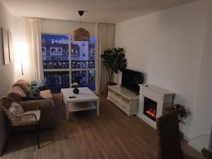 a living room with a couch and a fireplace at Apartamento Fuengirola Costa in Fuengirola