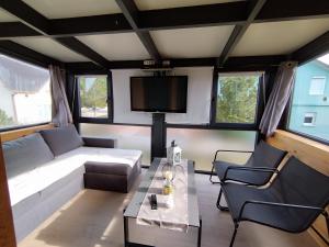 a living room with a couch and a tv at Vikend kuća Davor in Risovac