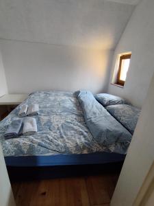 a bed with a blue comforter in a bedroom at Vikend kuća Davor in Risovac