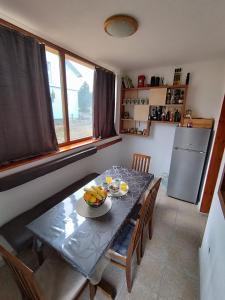 a kitchen with a table with a bowl of fruit on it at Vikend kuća Davor in Risovac