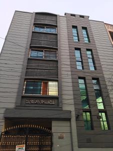 a tall building with a sign on it at Khaleel Manzil Luxe Stays in Hyderabad