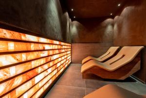a bench in a room with a wooden wall at Meiser SPA Resort in Fichtenau