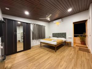 a bedroom with a bed in the middle of a room at Chandralok Service Apartments in Kolhapur +55 photos