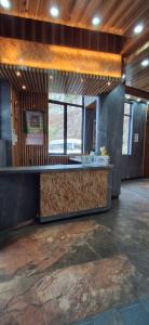 a restaurant with a counter in the middle of a room at Beyond Baari Inn in Darjeeling