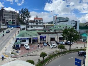 a city with cars parked in a parking lot at LJ's Burnham Homestay in Baguio