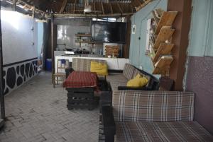 a living room with two couches and a tv at Kituri Hostel in Dar es Salaam