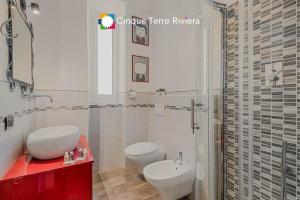 a bathroom with a toilet and a sink and a shower at Graffiti House Luxury Apartment in La Spezia +7 photos