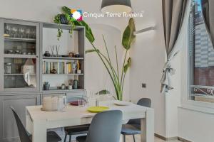 a dining room with a white table and chairs at Graffiti House Luxury Apartment in La Spezia