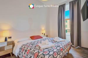 a bedroom with a bed with two towels on it at Graffiti House Luxury Apartment in La Spezia