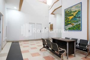 a meeting room with a table and chairs at Aster Triplets Guest House JCM Mitra RedDoorz in Yogyakarta
