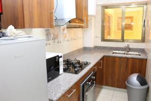 a kitchen with a stove and a sink at LOUMIA Residency in Douala +9 photos