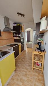 a kitchen with a sink and a yellow counter top at Lukite House in Tías