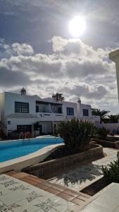 a large white house with a swimming pool at Lukite House in Tías