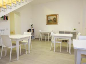 a dining room with white tables and white chairs at Affittacamere 1888 in Pietrelcina