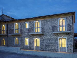 a brick building with lit up windows and lights at Affittacamere 1888 in Pietrelcina