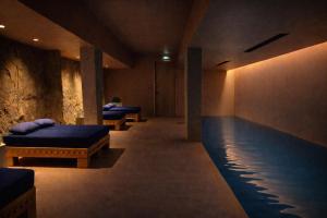 a room with two beds and a swimming pool at Hôtel Mylos - Cargèse, Piscine Intérieure et Extérieure in Cargèse