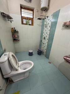 a bathroom with a toilet and a shower at Meraki Homes in Karnal