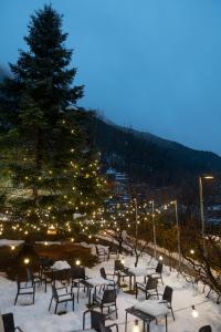 a group of tables and chairs in the snow at Hotel Coray by Pierre & Vacances in Encamp
