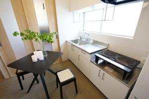 a small kitchen with a table and a sink at 伯旺ビル 403 in Kanazawa