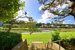 a park with a river and buildings in the background at 伯旺ビル 403 in Kanazawa