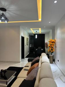 a living room with a couch and a table at Emerald Enclave Residence in Gwarinpa