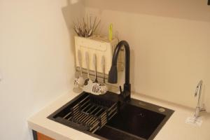a kitchen counter with a sink and a kitchenilit at Lemi - Homestay in Hue in Hue +58 photos