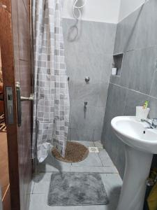 a bathroom with a shower with a toilet and a sink at Happy Dany Stays in Kiahuria