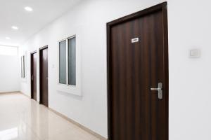 a wooden door with a sign on it in a hallway at FabHotel Shivay in Indore
