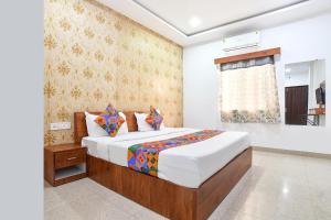 a bedroom with a bed and a window at FabHotel Shivay in Indore +33 photos