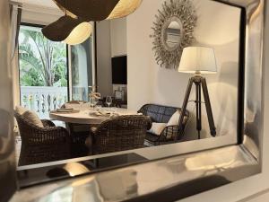 a dining room with a table and chairs and a mirror at Scirocco - Villa Marina in Marina di Andora