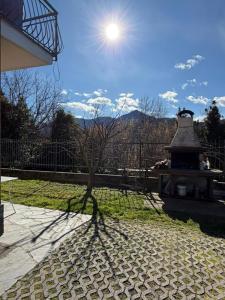 a shadow of a tree next to a fence at Lily House in Luino