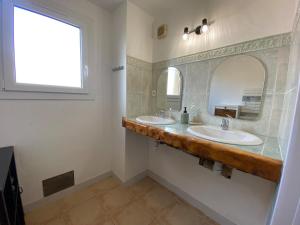 a bathroom with two sinks and a mirror at La Villa Soleil in Veynes +42 photos