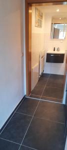 a kitchen with a tiled floor in a room at Ferienwohnung Barfelde in Dötzum +6 photos