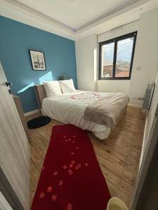 a bedroom with a bed and a red carpet at Maison in Maisdon-sur-Sèvre