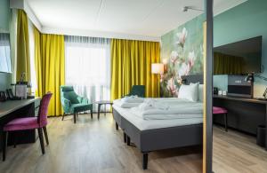 a hotel room with two beds and a desk at Thon Hotel Ski in Ski +43 photos