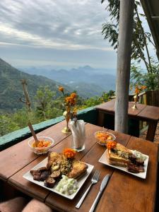 a wooden table with plates of food on it at MOYE MOYE Ella in Ella