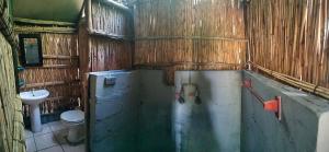 a bathroom with a toilet and a sink at Amangwane Tented Camp in Kosi Bay +51 photos