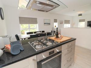 a kitchen with a stove and a counter top at Summer Rose in Craster