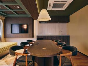 a conference room with a wooden table and chairs at illi Eme Tokyo-Toranomon in Tokyo +26 photos