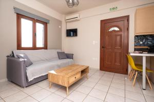 a living room with a couch and a table at Mary's Panorama Houses in Gialova