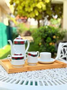a tray with two tea sets on a table at Nishi Villa in Negombo