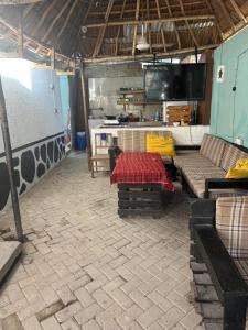 a living room with couches and a table and a tv at Kituri Hostel in Dar es Salaam +46 photos